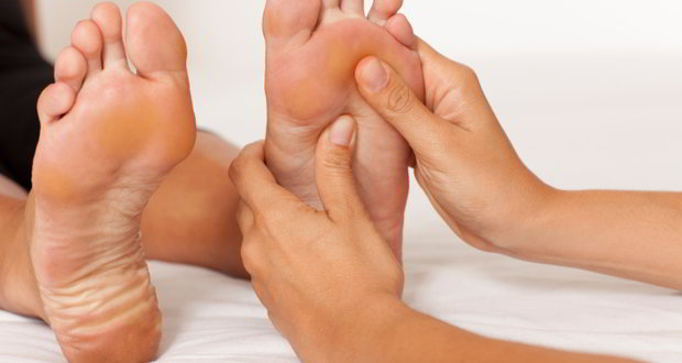 A practitioner administering acupressure to a patients foot.