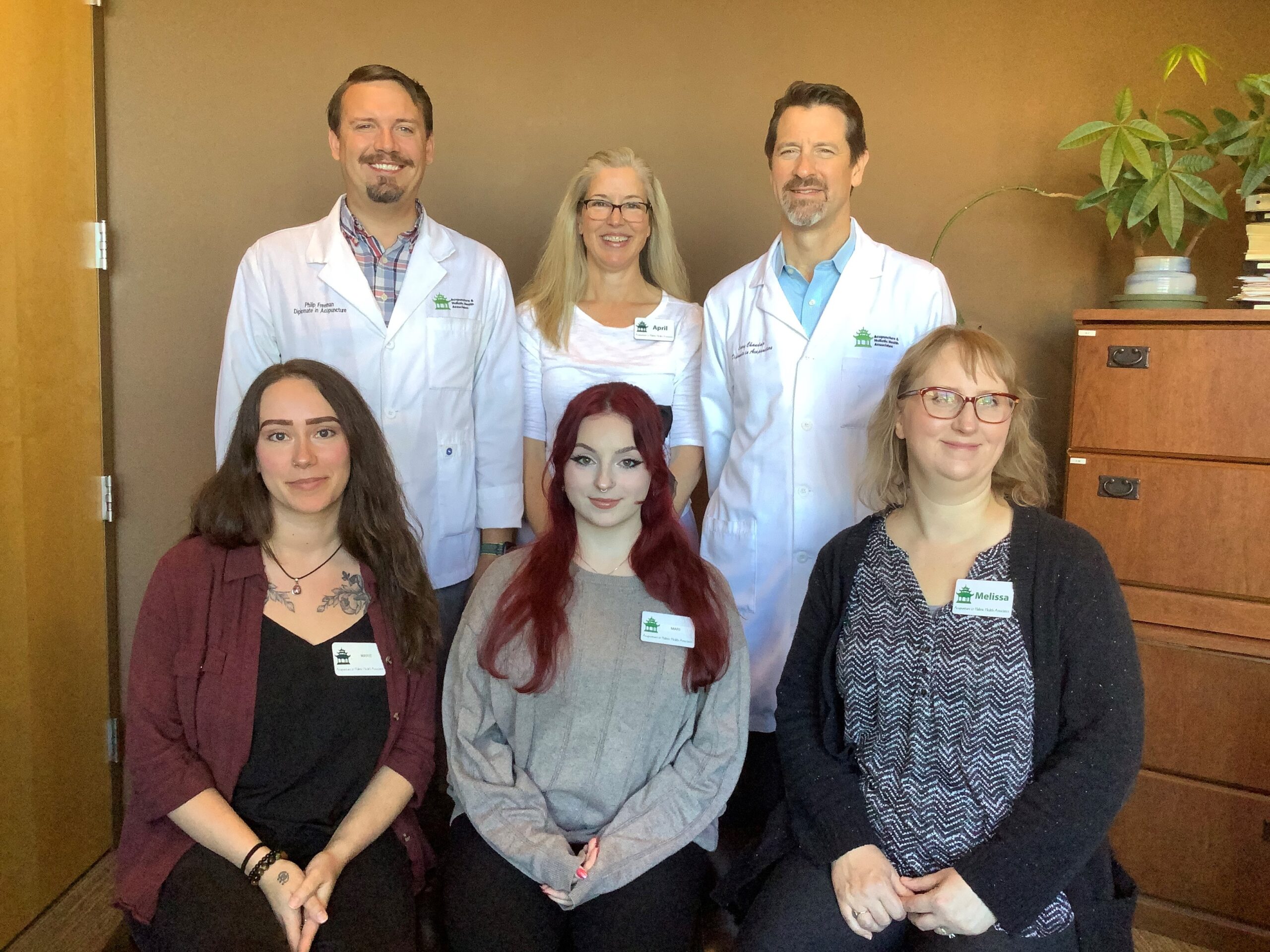 The image is of the staff at Acupuncture and Holistic Health Associates. It shows three people standing in the back (Philip, April, and Curry) and three people sitting in the front (Marie, Mari, and Melissa).