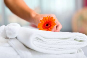 A flower is being put on some blankets. This represents how acupuncture can encourage restful sleep