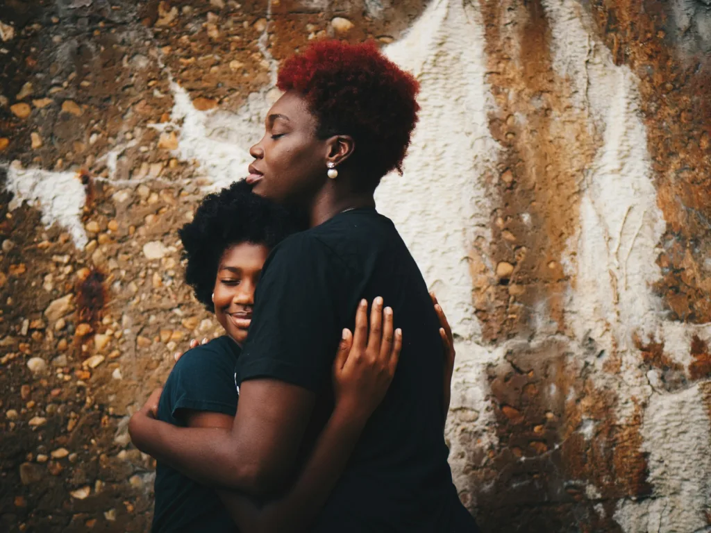 mother and daughter hugging each other